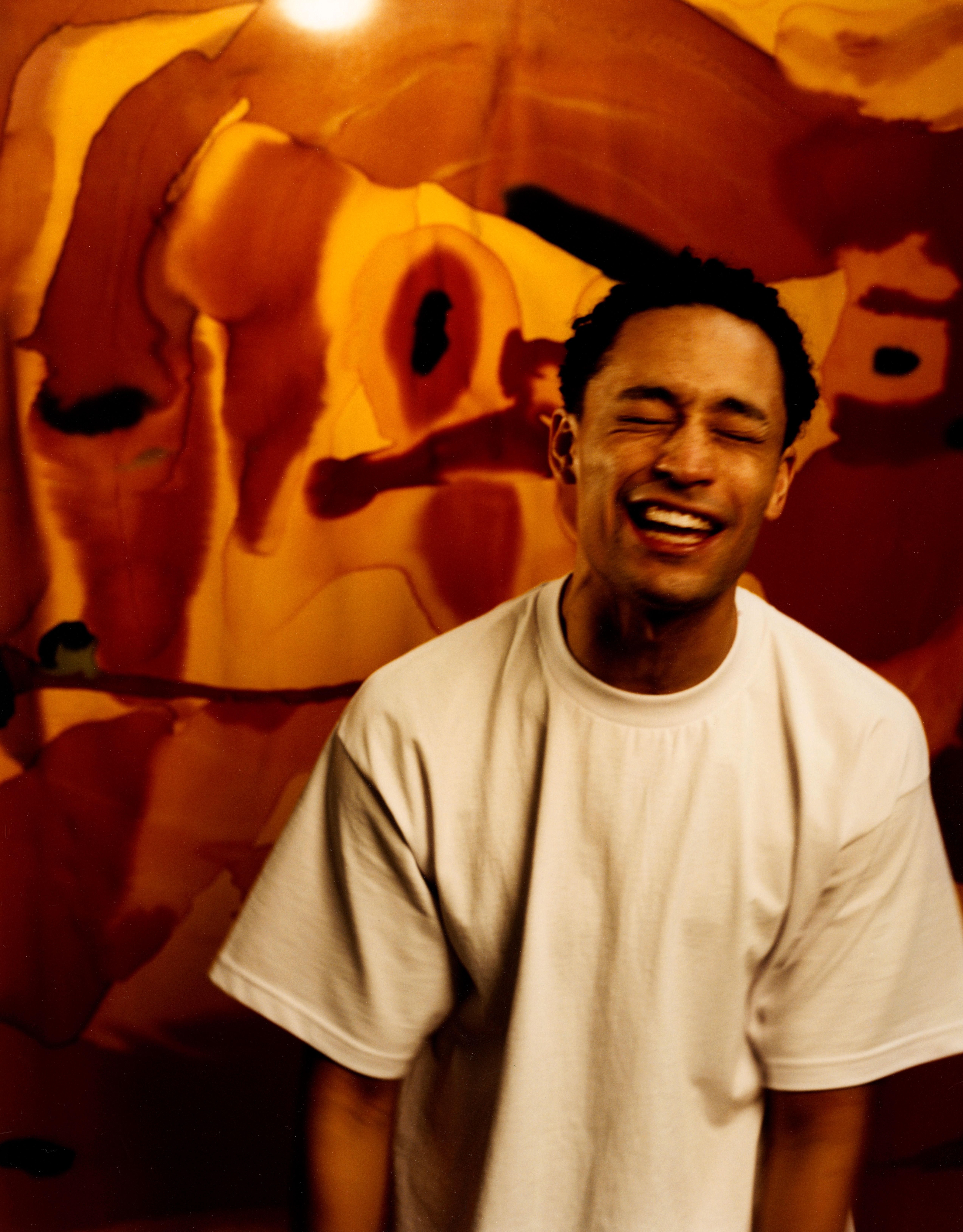 Loyle Carner poses in front of autumnal background ahead of the release of new album Hugo, shot by Jack Davidson