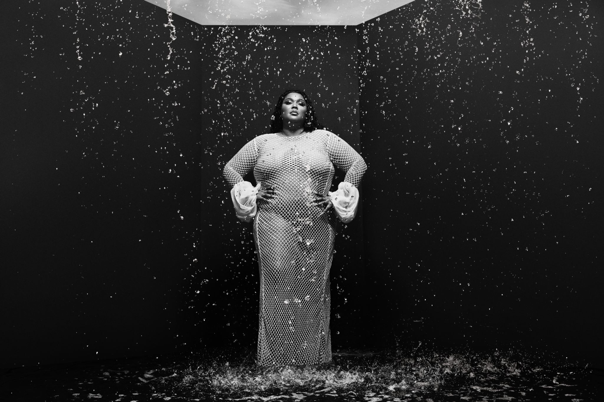 Lizzo, surrounded by rainfall, poses for the camera while promoting her new album, Special