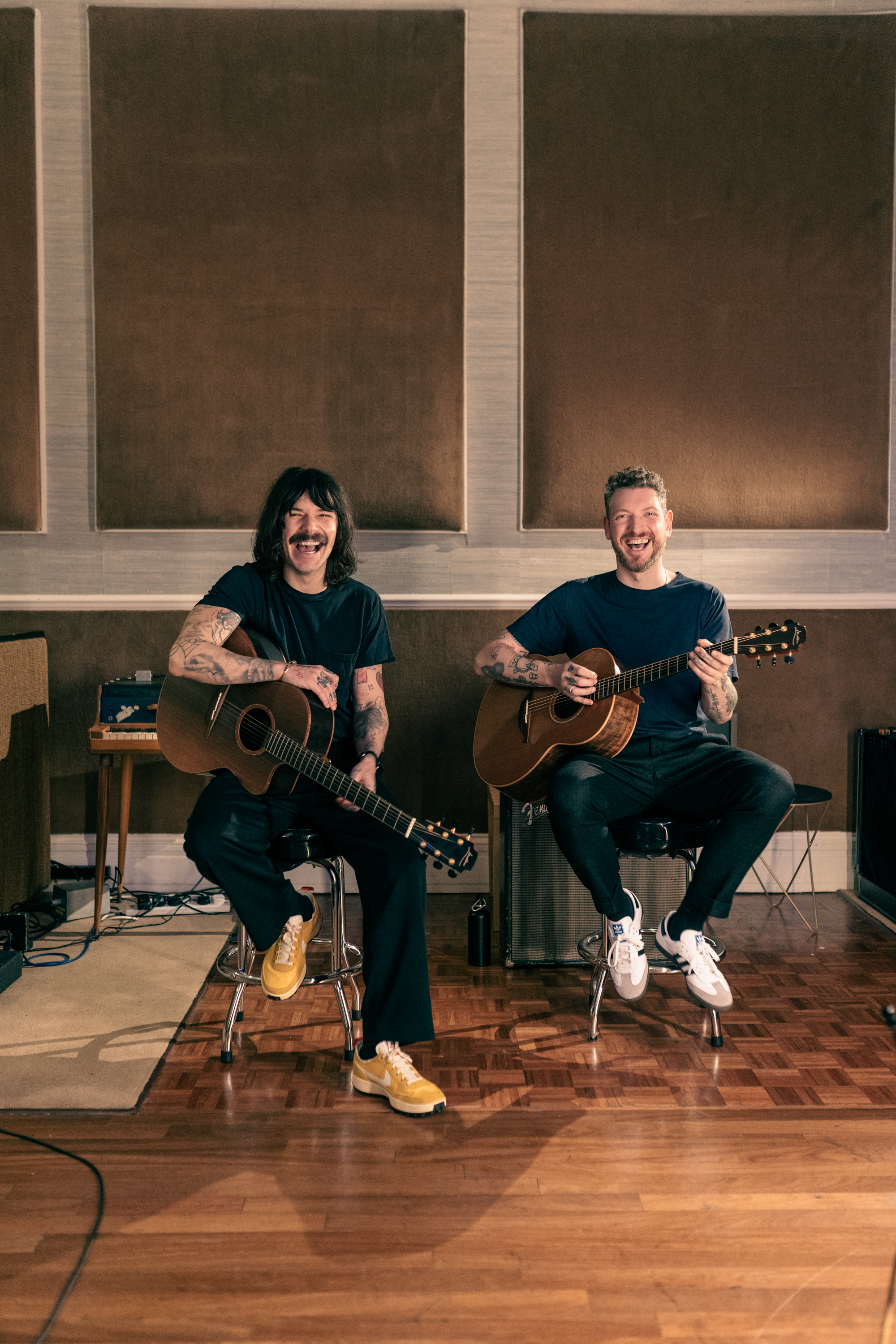 Nathan Connolly (L) and Simon Neil (R) pose in the studio with guitars.